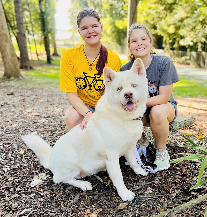 CARA-Monthly-Donor-image Image of two people with a white dog